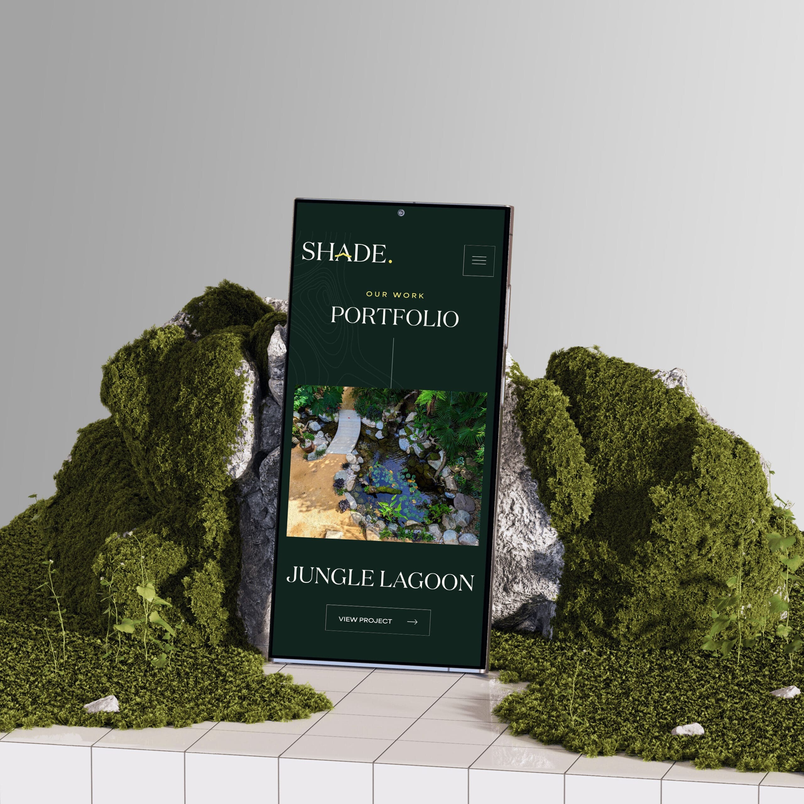 Smartphone displays a website with a portfolio titled "Jungle Lagoon," set against a backdrop of green moss and rocks on a tiled surface.